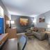 Holiday Inn St Louis Sw - Route 66 By IHG room with sofa, armchair, coffee table and wall mirror in St. Louis
