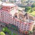 Rainbow Ruiru Resort in Nairobi, aerial view of the pink hotel building with curved wings and rooftop terrace