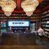 Stamba Hotel in Tbilisi lobby with bookshelves, crystal chandeliers and reception desk