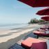 Khaolak Laguna Resort in Khao Lak: beachfront loungers and red umbrellas overlooking the sandy shore