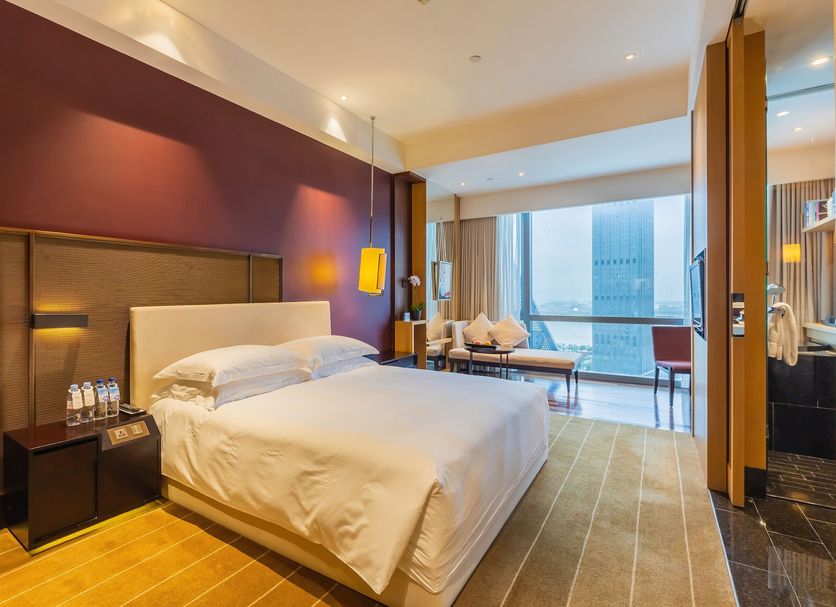 Hotel Kapok Shenzhen Bay room in Shenzhen with king bed, floor-to-ceiling windows and city view