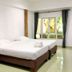 Lopburi Inn Hotel in Lop Buri guest room with two beds and window view