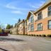 Motel 6 Surrey Bc in Surrey exterior with parking lot, trees, and a row of guest rooms