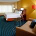 Fairfield Inn & Suites Parsippany guest room with king bed, sofa, desk, and TV