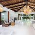 Le Cameleon Boutique Hotel lobby with open-air lounge, hanging lights and pool view in Puerto Viejo de Talamanca