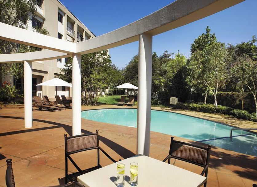 Garden Court Eastgate in Johannesburg with outdoor pool, patio seating and sun umbrellas