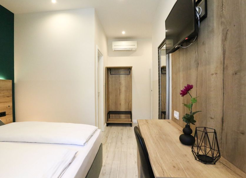 Casablanca Boutique Bed&Breakfast Zagreb room with twin beds, desk, wall TV and wood accent wall