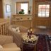 Haus Sonnwend in Alpbach lobby with beige chairs, floral table, rug, and wood-paneled entrance door