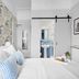 Sandway House, Torquay: bright guest room with king bed, floral wallpaper, and blue en suite bathroom