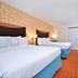 Fairfield Inn and Suites by Marriott Asheboro guest room with two beds, TV, and patterned carpet