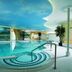 Indoor pool at Landhaus Zu den Rothen Forellen in Ilsenburg with curved blue ceiling and handrail