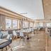 Sporthotel Olymp in Obergurgl restaurant with wooden tables, large windows, and mountain views