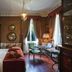 Hotel de la Ville Monza guest room with king bed, desk, and classic wood-paneled decor
