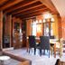 Hospedium Hacienda Las Cavas in Olmedo: rustic dining room with wooden beams, fireplace, and TV