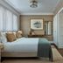 Miiro Borneta Barcelona bedroom with king bed, wood accents, and large windows