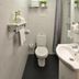 Hotel Schilberg in Slenaken bathroom with toilet, sink, shower curtain, and towel shelf