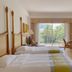 Forum For Asia Gold Coast Hotel Qionghai room with twin beds and balcony view of palm trees