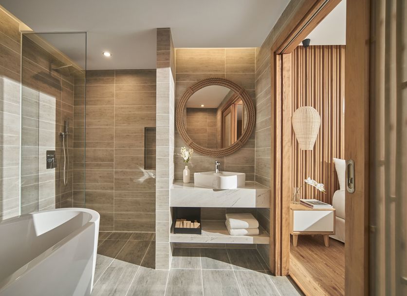 Vias Hotel Vung Tau bathroom with freestanding tub, walk-in shower, and vanity in Vung Tau