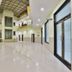 OYO 2494 Hotel Shree Plaza in Bharuch, bright lobby with high ceiling, glass doors, and polished floors