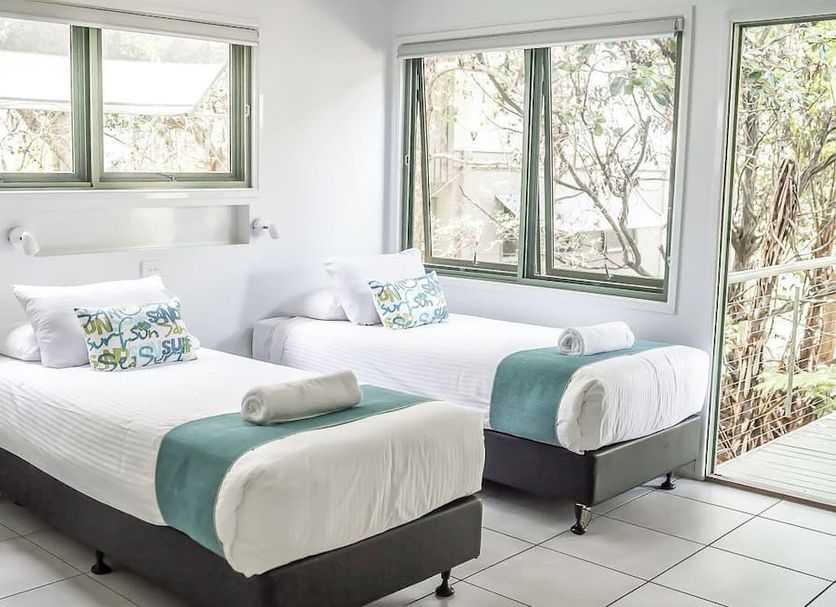 The Retreat Beach Houses in Peregian Beach: bright twin bedroom with large windows and garden views