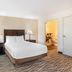 Best Western Plus Valdosta Hotel & Suites room with king bed, bedside lamps and adjoining bath