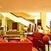 Pestana São Tomé lobby lounge with red sofas, staircase, and warm modern seating in São Tomé