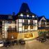 Hotel Royal Baltic 4 Luxury Boutique in Ustka, illuminated at dusk with cars parked outside