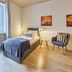 Arador City Hotel in Bad Oeynhausen guest room with twin beds, two chairs and a large window