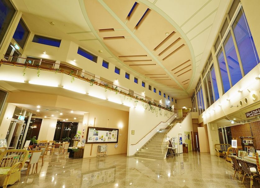Jungle Hotel Painu Maya in Taketomi lobby with high atrium, staircase and dining area
