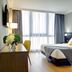 Hotel Oca Puerta del Camino room in Santiago de Compostela with bed, desk, and large window
