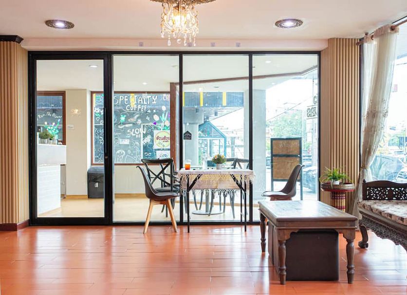 Sk Boutique Mahanakhon Bangkok lounge with glass doors, seating area, and city view