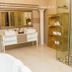 Ivory Manor Boutique Hotel Pretoria bathroom with freestanding tub, double vanity, glass shower and shelf unit