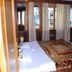 Himgiri Resorts, Dharamshala guest room with bed, wood-paneled windows and mountain view
