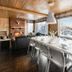 Auberge du Lac-a-l'Eau-Claire dining room with lake views, fireplace, and long table in Saint-Alexis-des-Monts