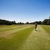 The Lodge At Meyrick Park in Bournemouth with a wide golf fairway under a clear blue sky