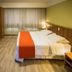 Tri Hotel Executive Caxias room in Caxias do Sul with bed, desk, TV and large window