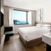 Fairfield by Marriott Busan room with large window and ocean view, modern bed and sink vanity