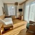 Haus Friedrichsburg in Bad Hofgastein guest room with bed, armchair, TV and balcony doors