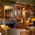 Hôtel Aoriste & Spa, Paris: stylish lounge with fireplace, bookshelves, seating and staircase