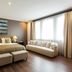 Quentin Boutique Hotel Berlin room with king bed, bench ottomans, sofa by large window