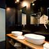 Suite Art Navona in Rome bathroom with double vessel sinks, mirrors, and dark modern finishes