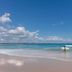Oaks Gold Coast Calypso Plaza Suites in Coolangatta with a surfer on the beach and ocean waves