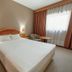 Estalagem Vianorte room in Matosinhos with double bed, bedside lamps and a window with curtains