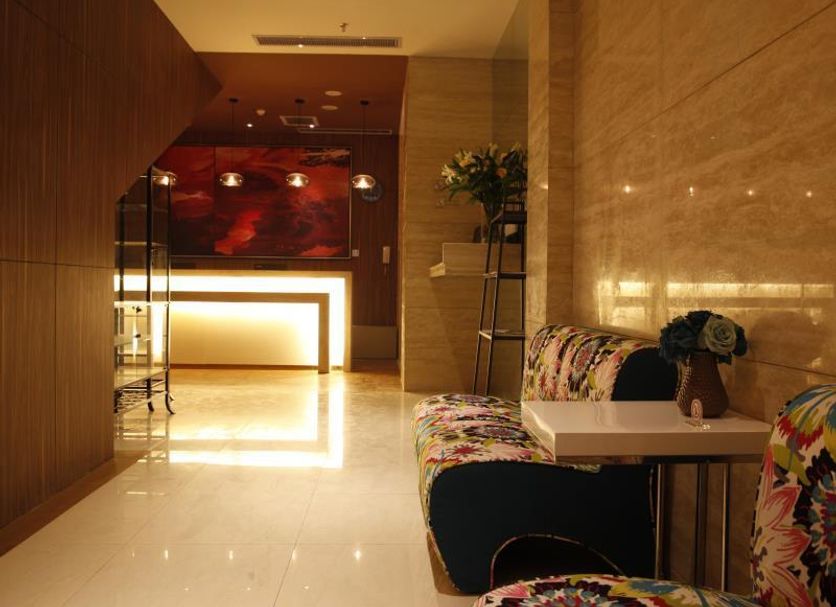 Century Star Urumqi Changjiang Road Hotel lobby with glossy marble floor and floral seating in Ürümqi