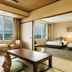 Kamenoi Hotel Yanagawa room with twin beds, large window views, and a sitting area in Yanagawa