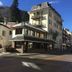 Hotel Le Centre in Brides-les-Bains on a mountain street, with balconies and snowy rooftops