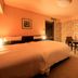 Richmond Hotel Naha Kumoji guest room in Naha with twin beds, floral accent wall and seating area