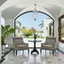 Caramel, A Grecotel Resort to Live lounge with arched opening, two chairs, and garden view in Adelianos Kampos