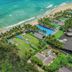 Aerial view of Naman Retreat in Da Nang with beachfront pools, lush gardens, and resort villas