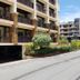 Jomtien Beach Residence in Pattaya with balconies, landscaped greenery, and driveway outside